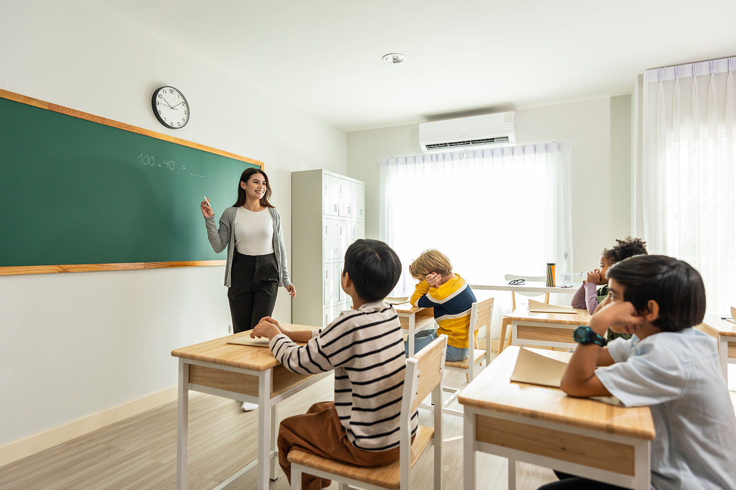 Group of student learn with teacher in classroom
