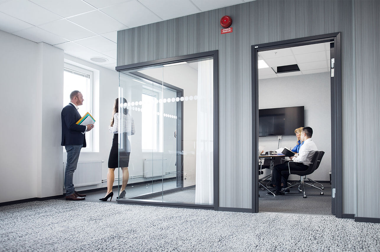 Architects working in office and talking in corrid