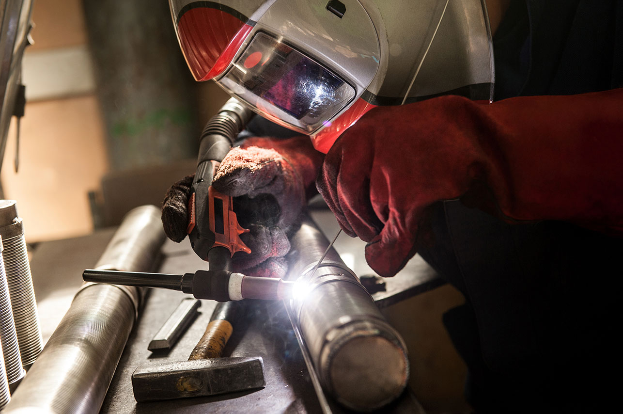 Closeup of man wearing mask welding in a workshop